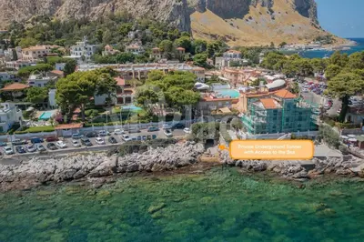 an aerial view of a town next to the water at M'Place - Mondello Residence in Palermo
