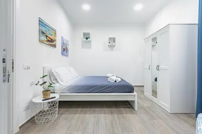 a bedroom with a bed and a walk in shower at GuestHost - La Casa di Martina - Palermo Central Apartments in Palermo