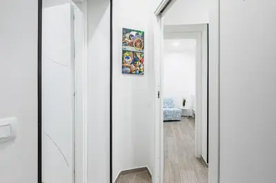a hallway with white walls and a mirror at GuestHost - La Casa di Martina - Palermo Central Apartments in Palermo