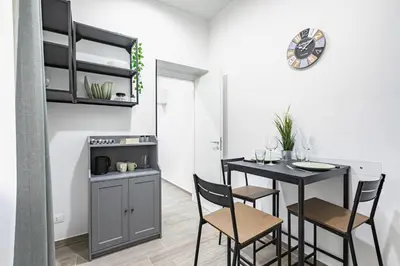 a kitchen and dining room with a table and chairs at GuestHost - La Casa di Martina - Palermo Central Apartments in Palermo