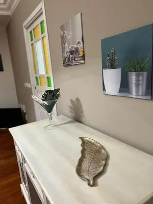 a table with a vase on top of it at MeliKris home in Palermo