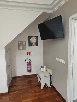 a living room with a flat screen tv on the wall at MeliKris home in Palermo
