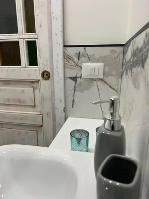 a bathroom with a sink and a soap dispenser at MeliKris home in Palermo
