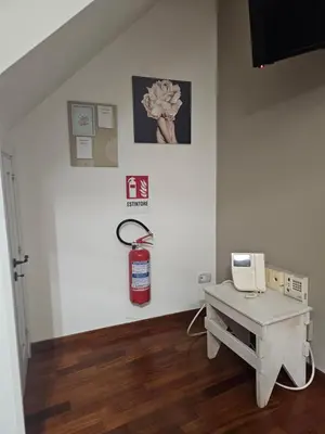 a room with a fire extinguisher on a wall at MeliKris home in Palermo
