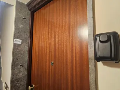 a wooden door in a room with a paper on it at MeliKris home in Palermo