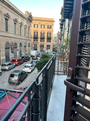 a balcony with cars parked on a city street at MeliKris home in Palermo