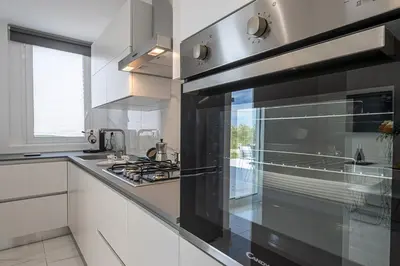 a kitchen with a stove top oven in a kitchen at Federica's House - Sporting Village in Scopello