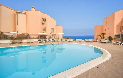 a large swimming pool in front of a building at Bilo 4 in Lido di Mondello