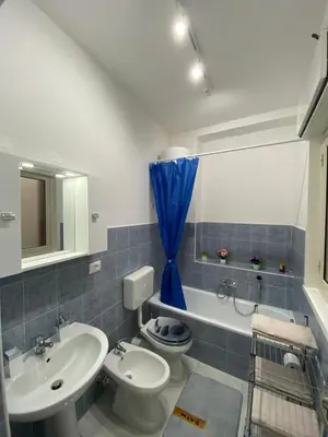 a bathroom with a sink and a toilet and a tub at Perla Diva Apartment in Palermo