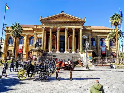 a horse drawn carriage in front of a building at Perla Diva Apartment in Palermo
