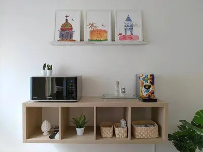 a microwave on a shelf in a living room at Appartamento Ai Murales in Palermo