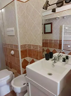 a bathroom with a white sink and a toilet at Appartamento Ai Murales in Palermo