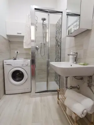 a bathroom with a washing machine and a sink at CasAnna in Castellammare del Golfo
