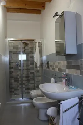 a bathroom with a shower and a sink and a toilet at CasAnna in Castellammare del Golfo