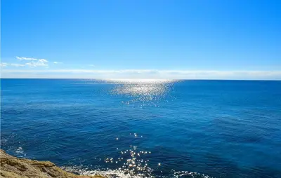 a large body of water with the sun reflecting on it at Bilo 4 in Lido di Mondello