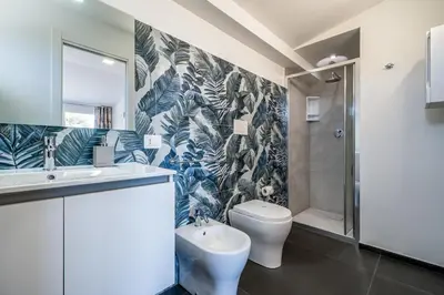 a bathroom with a glass shower and a toilet at Villa Dell'Ulivo con piscina privata By Sicily Home Solutions in Alcamo