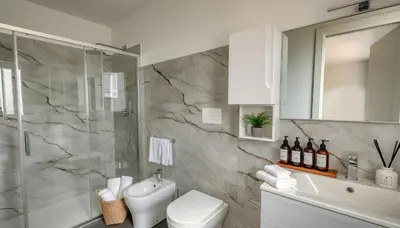 a bathroom with a shower and a toilet and a sink at Villa Dell'Ulivo con piscina privata By Sicily Home Solutions in Alcamo