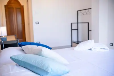 a bedroom with a bed and an open window at Le Tartane B&b Guidaloca in Castellammare del Golfo