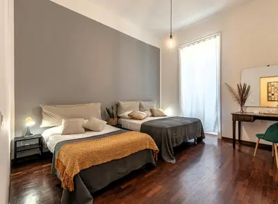 a bedroom with two beds and a window at Don Mimì Leisure in Palermo