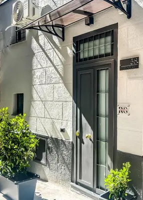 a black door on the side of a building at Rouge Suite & SPA PALERMO CENTRO in Palermo