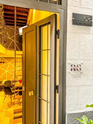 an open door to a room with a chair at Rouge Suite & SPA PALERMO CENTRO in Palermo