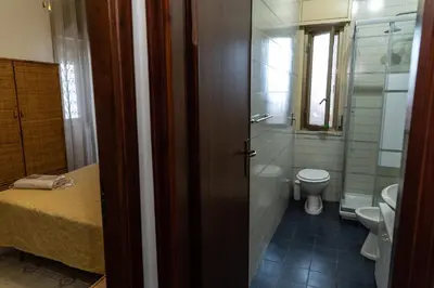 a small bathroom with a toilet and a sink at L'isola Che Non C'è in Isola delle Femmine