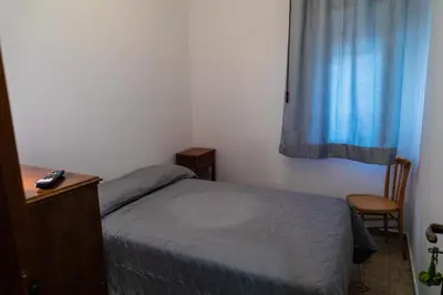 a small bedroom with a bed and a window at L'isola Che Non C'è in Isola delle Femmine