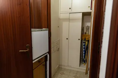 a kitchen with a white refrigerator and a closet at L'isola Che Non C'è in Isola delle Femmine