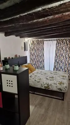 a bedroom with a bed and a table in a room at Virginia House 3 in Palermo
