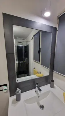 a bathroom with a sink and a large mirror at Virginia House 3 in Palermo
