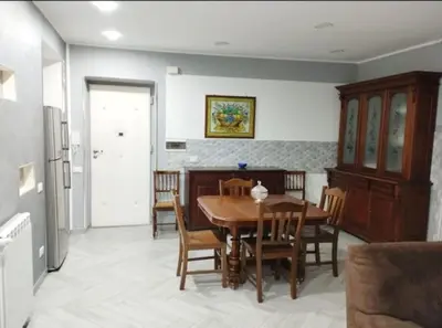 a kitchen and dining room with a table and chairs at La casetta dei limoni in Palermo