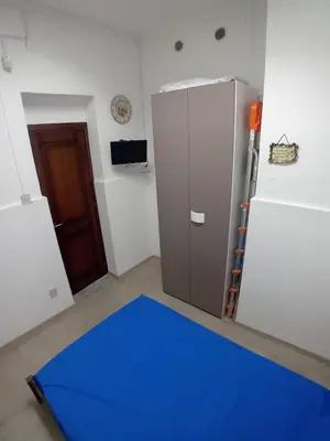 a kitchen with a refrigerator and a blue floor at NONNA MARI' in Palermo