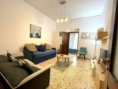 a living room with a couch and a tv at NONNA MARI' in Palermo