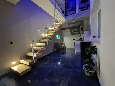 a hallway with stairs and a table in a room at Confort Home 73 in Palermo