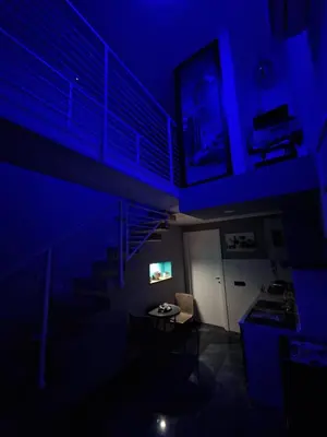 a blue room with stairs and a table and chairs at Confort Home 73 in Palermo