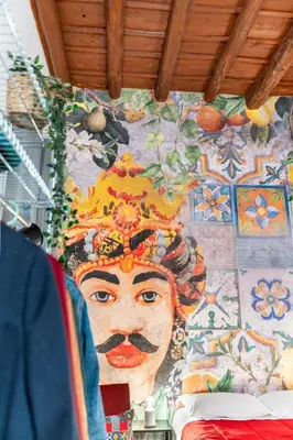 a wall with a painting of a woman on it at CASA FLORIO in Palermo