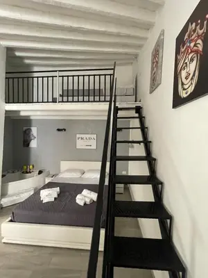 a bedroom with a bunk bed and a staircase at RC SUITE TERMINI IMERESE in Termini Imerese