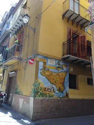 a mural on the side of a building at Sicula Liz & Lulù in Palermo