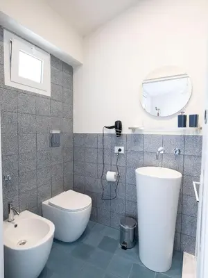 a bathroom with a toilet and a sink at Piricù Apartments in Castellammare del Golfo