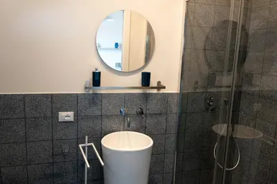 a bathroom with a sink and a mirror at Piricù Apartments in Castellammare del Golfo