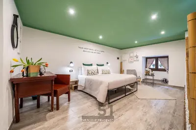 a bedroom with a bed and a desk and aaptop at Holiday Home GaribaldiOM Palermo Centro Storico! in Palermo