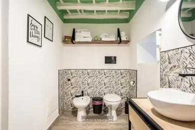 a bathroom with a sink and two toilets at Holiday Home GaribaldiOM Palermo Centro Storico! in Palermo