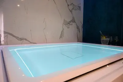 a bath tub with blue lighting in a room at B&B Maqueda - Room & Suite in Palermo