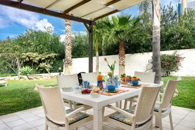 a white table and chairs on a patio at Villa levante Macari in Macari