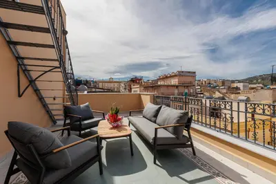 a balcony with two chairs and a couch and a table at Palazzo Orangea 2 piano in Bagheria