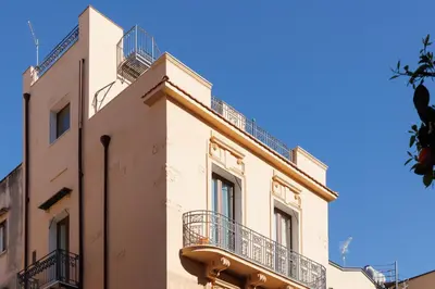 a building with balconies on the side of it at Palazzo Orangea 2 piano in Bagheria