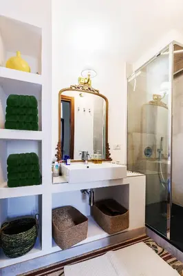 a bathroom with a sink and a shower at Palazzo Orangea 2 piano in Bagheria