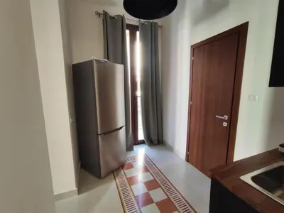 a kitchen with a stainless steel refrigerator in a room at Palazzo Orangea 2 piano in Bagheria