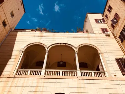a building with a balcony on top of it at Palazzo Ventimiglia Lodge & Suites in Palermo