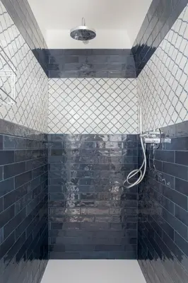 a bathroom with a shower with blue tiles at Palazzo Ventimiglia Lodge & Suites in Palermo